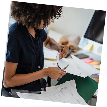 Team member reviewing documents at a desk