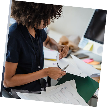 Team member reviewing documents at a desk